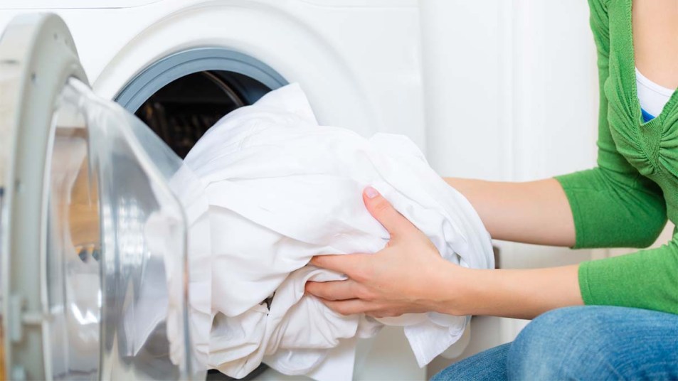Woman washing a load of white clothes